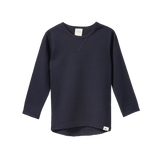 Navy organic merino wool long sleeve essential tee with crew neck and scooped hem.